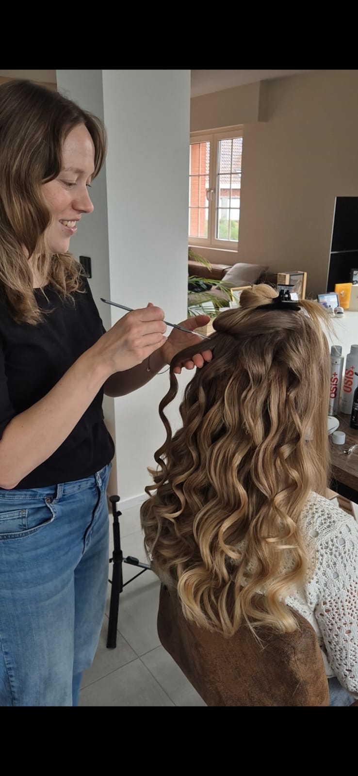 Heleen aan het werk: krult haar en lacht naar de camera